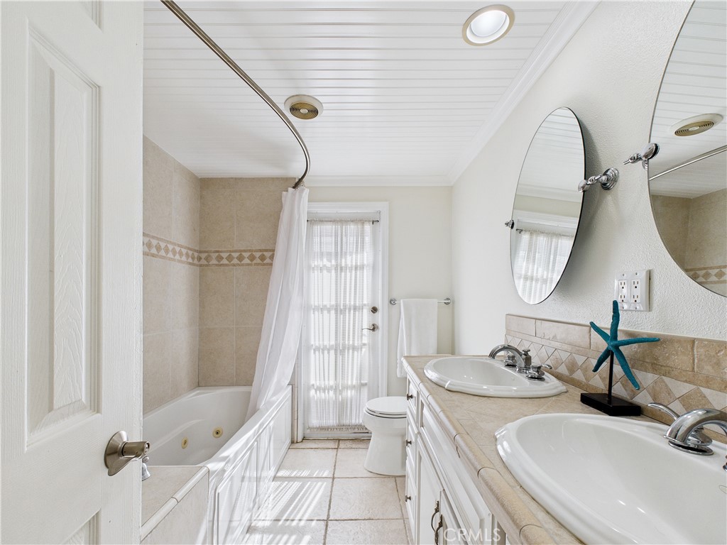 2857 Ellesmere Avenue Costa Mesa, CA 92626 - Photo 20 of 45 a bathroom with a sink and a mirror