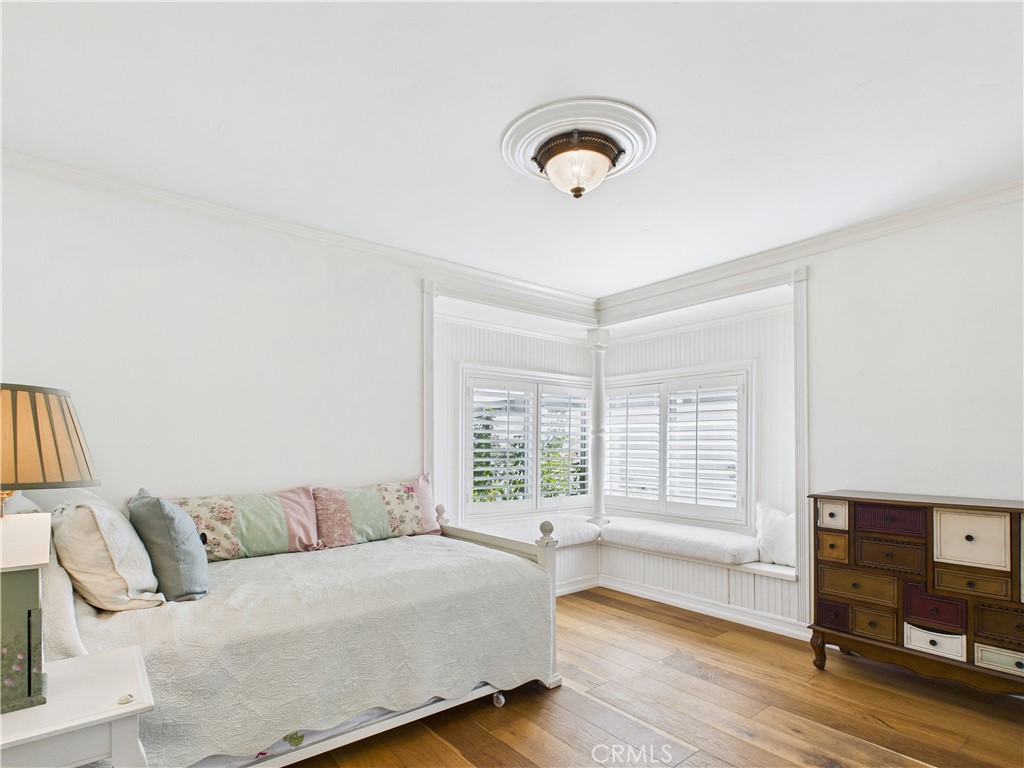 2857 Ellesmere Avenue Costa Mesa, CA 92626 - Photo 21 of 45 a spacious bedroom with a bed and wooden floor
