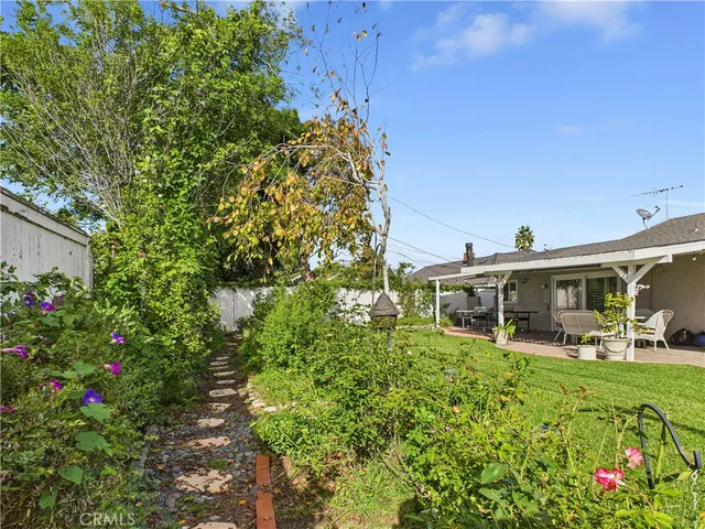 a front view of a house with a garden and patio