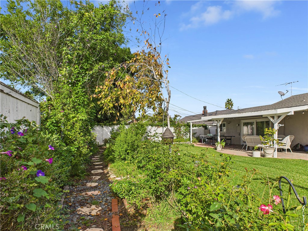 2857 Ellesmere Avenue Costa Mesa, CA 92626 - Photo 28 of 45 a view of a house with a big yard and garden