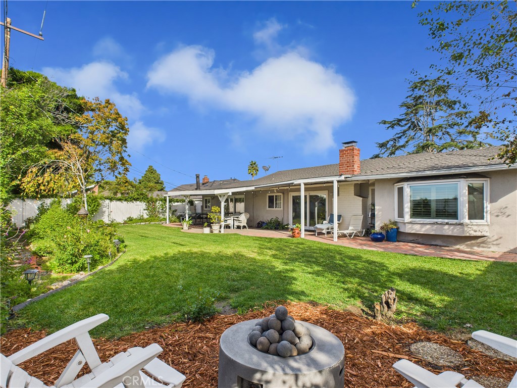 2857 Ellesmere Avenue Costa Mesa, CA 92626 - Photo 29 of 45 a front view of a house with a garden and patio