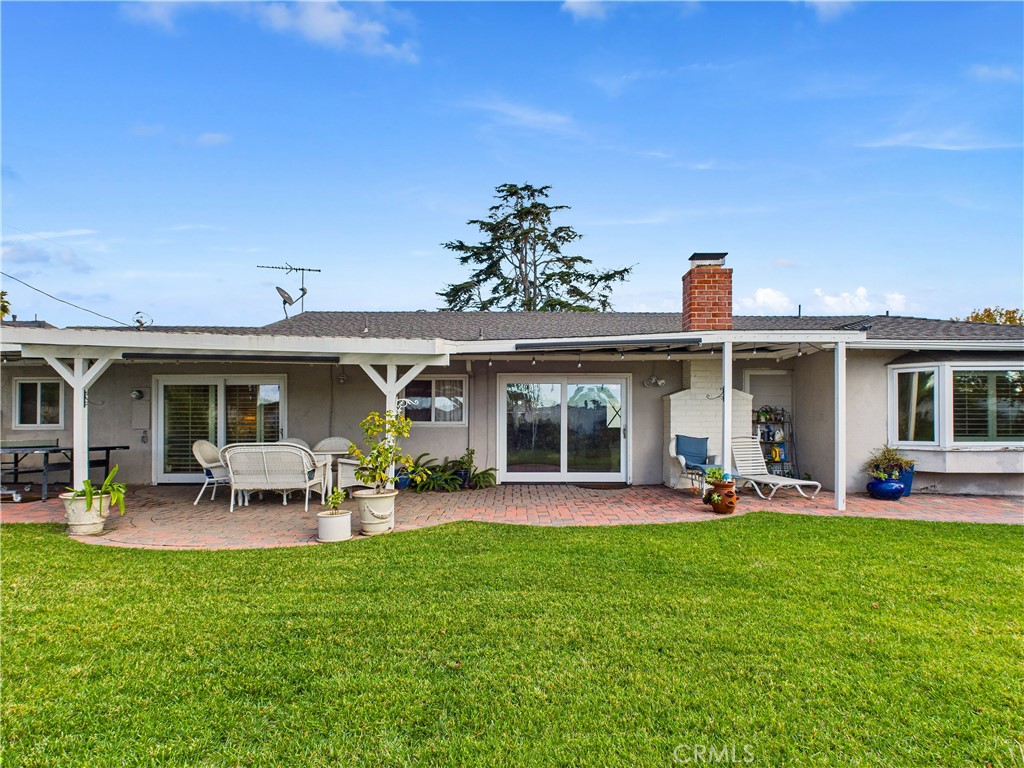 2857 Ellesmere Avenue Costa Mesa, CA 92626 - Photo 30 of 45 a front view of house with a garden and outdoor seating