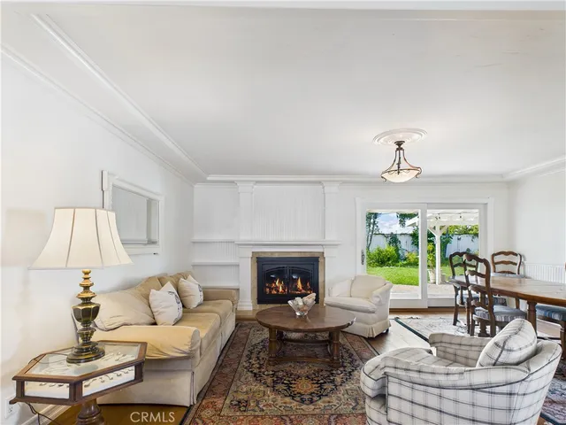 a living room with lots of furniture and view of kitchen