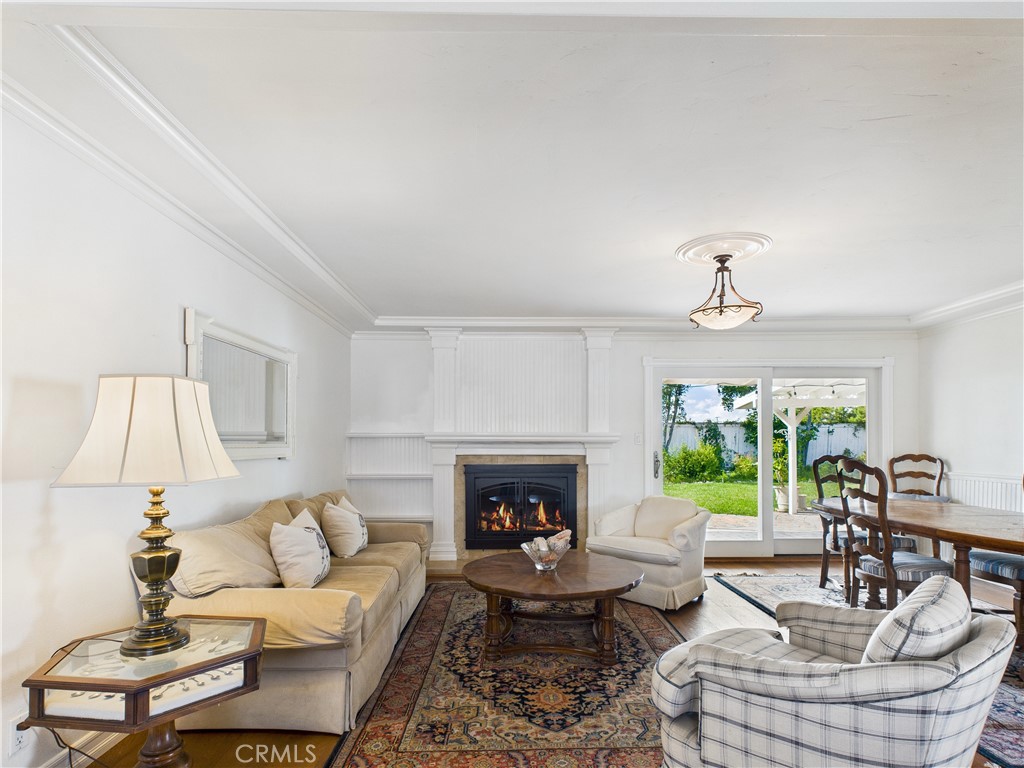 2857 Ellesmere Avenue Costa Mesa, CA 92626 - Photo 6 of 45 a living room with furniture a fireplace and a large window