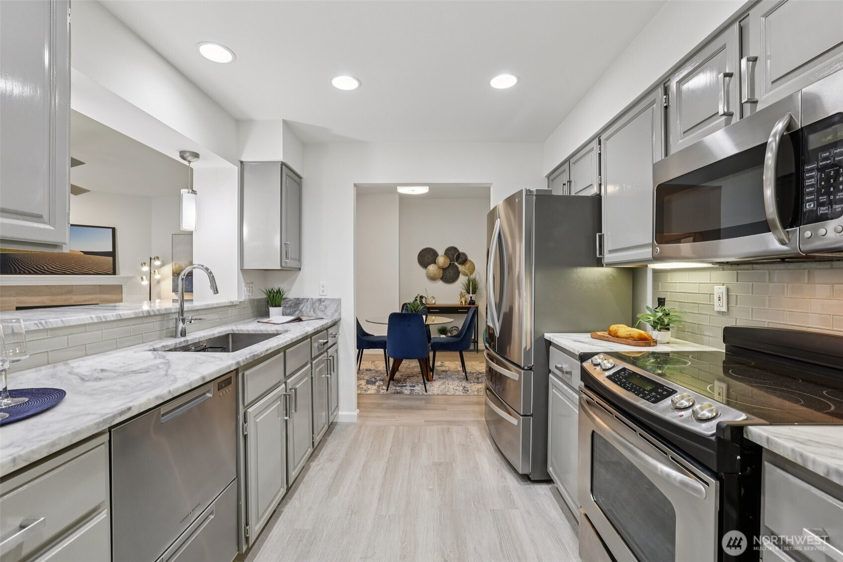 3625 224th Place Southeast Issaquah, WA 98029 - Photo 13 of 39 a kitchen with stainless steel appliances granite countertop a sink stove and refrigerator