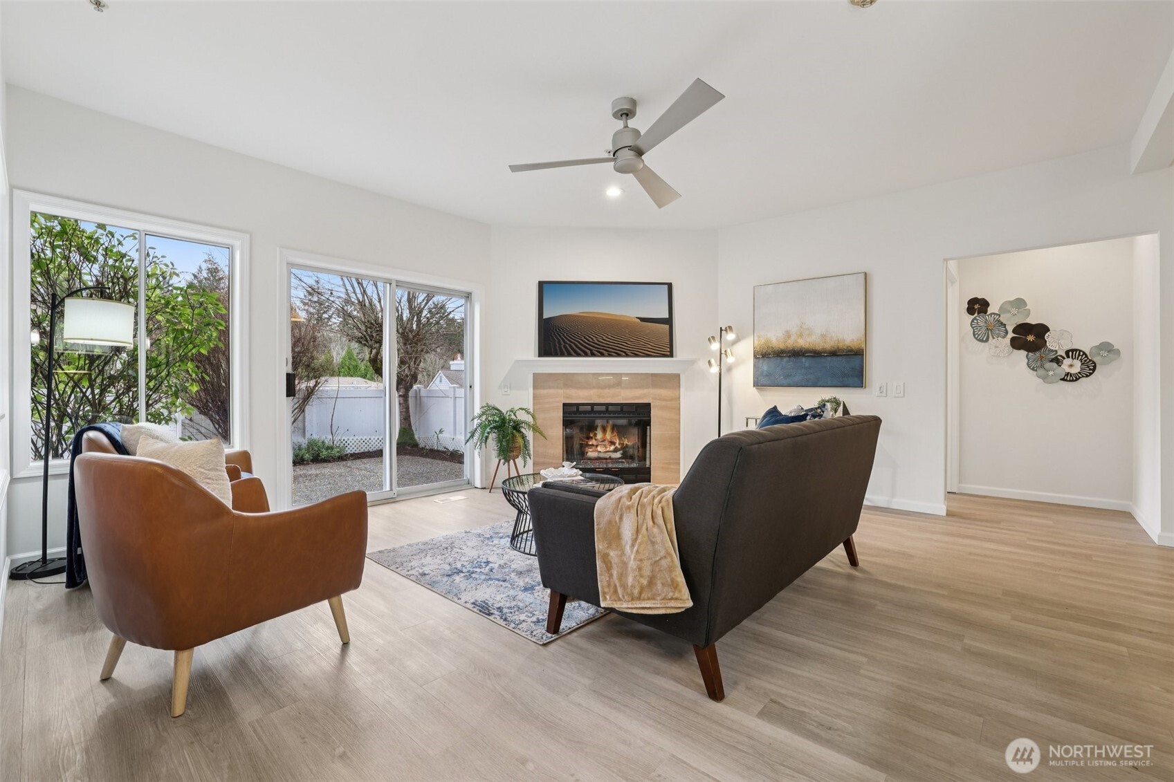 3625 224th Place Southeast Issaquah, WA 98029 - Photo 6 of 39 a living room with furniture a fireplace a flat screen tv and large windows