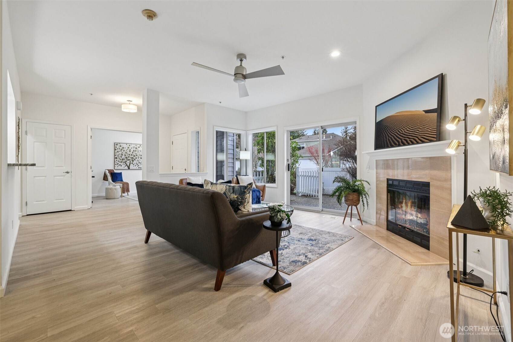 3625 224th Place Southeast Issaquah, WA 98029 - Photo 8 of 39 a living room with furniture a fireplace and a flat screen tv