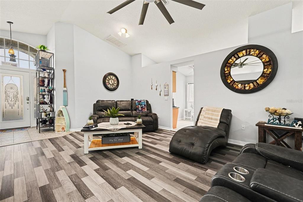 11428 Dorian Court New Port Richey, FL 34654 - Photo 12 of 30 a living room with furniture a clock on wall and a table