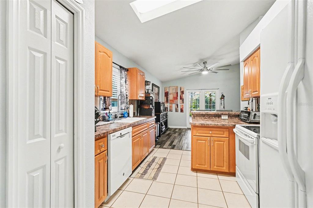 11428 Dorian Court New Port Richey, FL 34654 - Photo 16 of 30 a large kitchen with stainless steel appliances granite countertop a refrigerator and a stove top oven