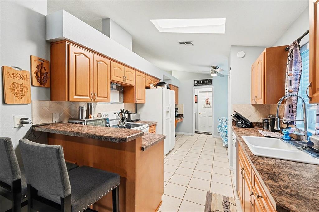 11428 Dorian Court New Port Richey, FL 34654 - Photo 17 of 30 a kitchen with stainless steel appliances granite countertop a sink stove and refrigerator