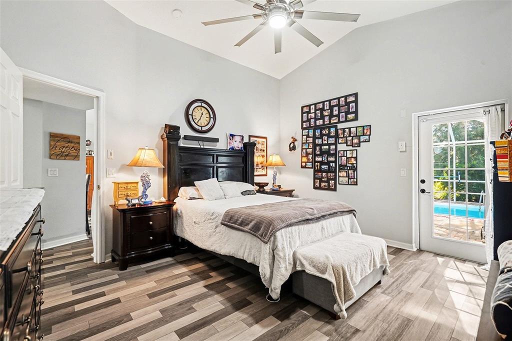 11428 Dorian Court New Port Richey, FL 34654 - Photo 20 of 30 a bedroom with a bed and a chandelier