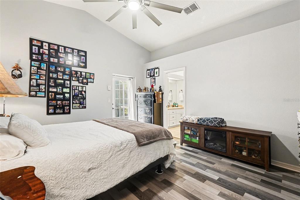 11428 Dorian Court New Port Richey, FL 34654 - Photo 22 of 30 a bedroom with a bed and a tv