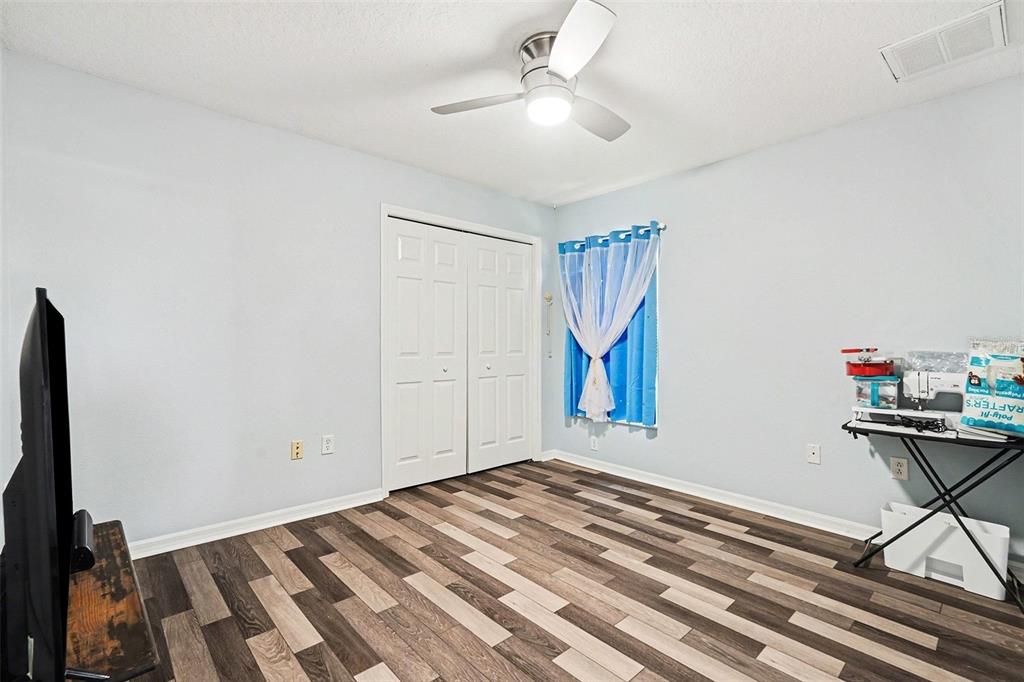 11428 Dorian Court New Port Richey, FL 34654 - Photo 27 of 30 a view of a room with gym equipment and a flat screen tv