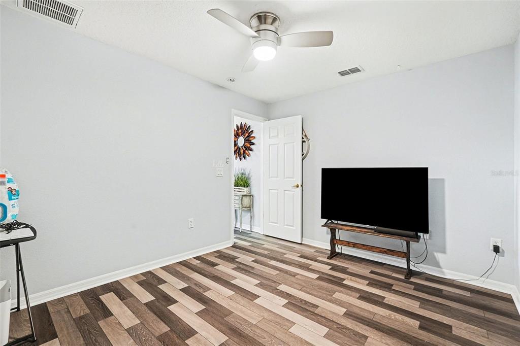 11428 Dorian Court New Port Richey, FL 34654 - Photo 28 of 30 a bedroom with a bed and a flat screen tv