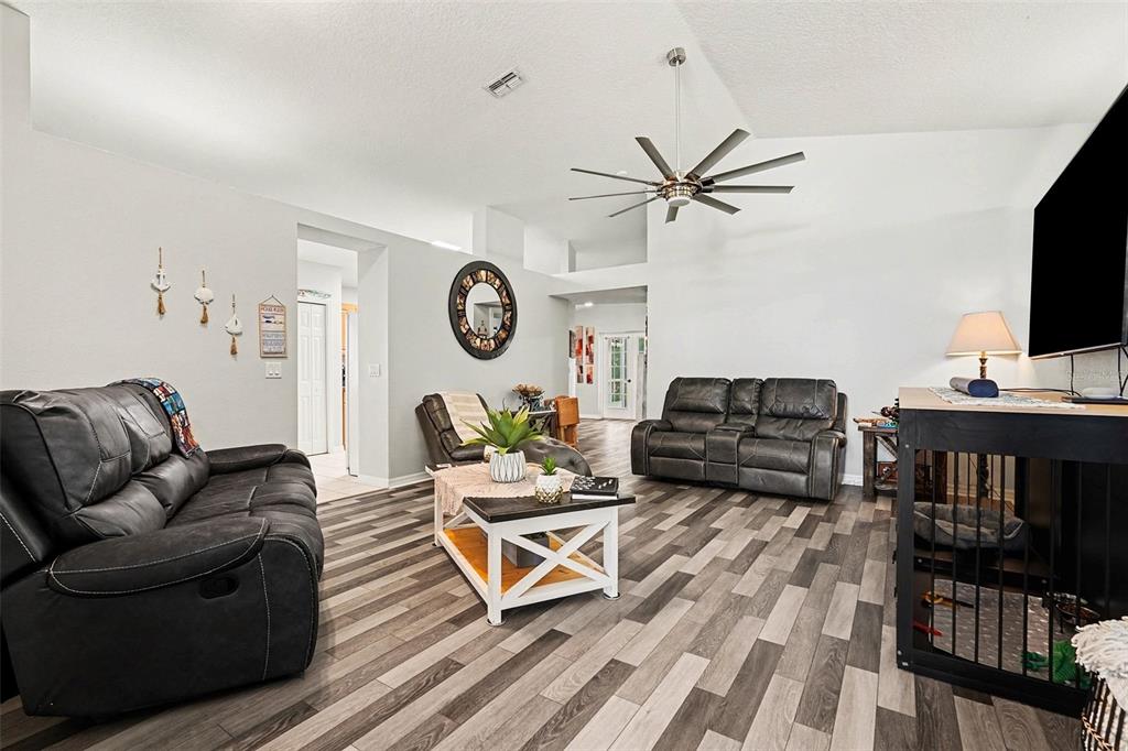 11428 Dorian Court New Port Richey, FL 34654 - Photo 3 of 30 a living room with furniture a clock tv and a window