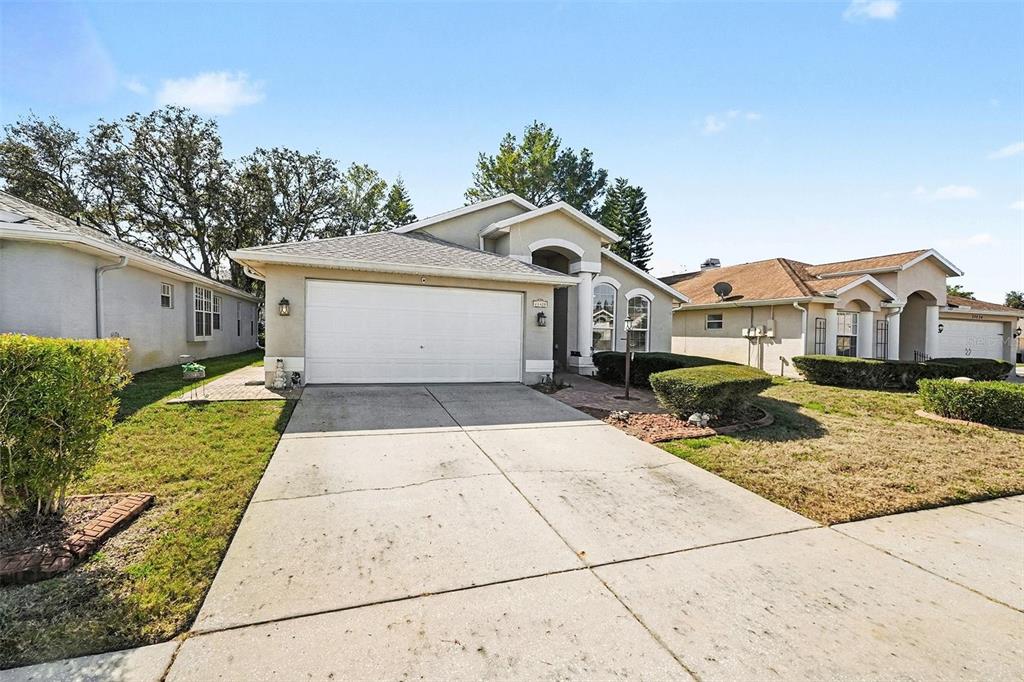 11428 Dorian Court New Port Richey, FL 34654 - Photo 6 of 30 a front view of a house with a garden