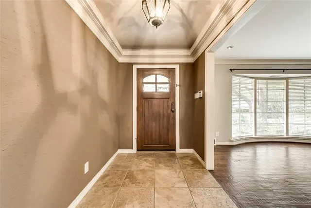 a view of a livingroom with wooden floor and a ceiling fan