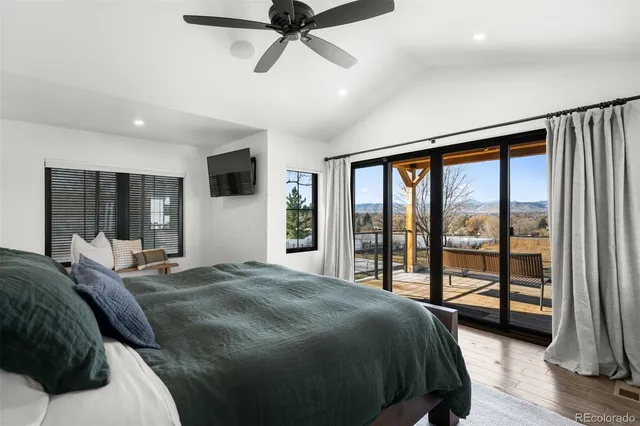 a bed sitting in a bedroom next to a window with a chandelier