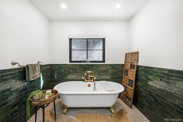 a bathroom with a tub and a shower