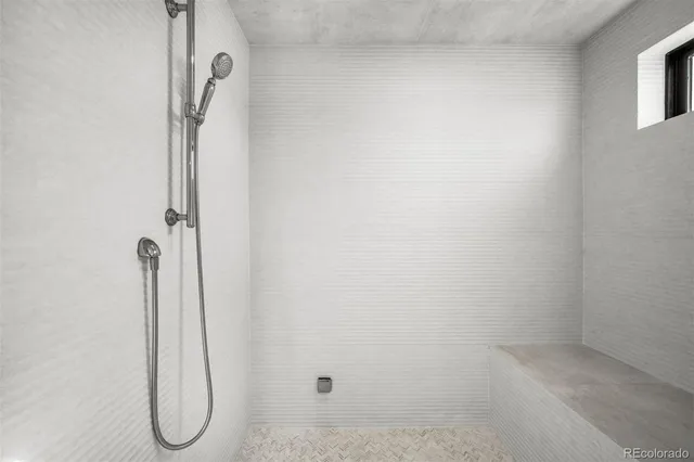 a living room with a bed furniture and a flat tv screen