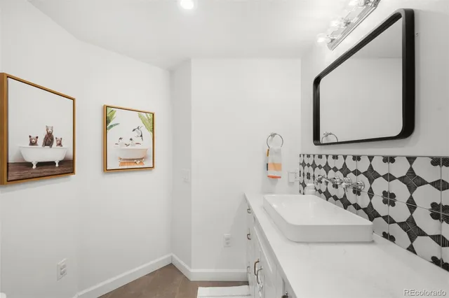 a bathroom with a sink mirror shower and toilet