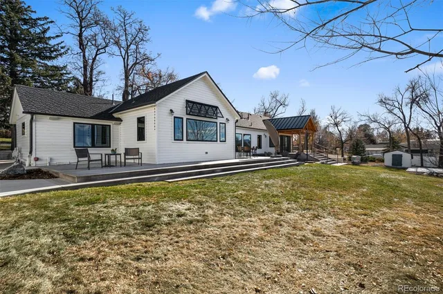 an aerial view of a house with swimming pool and porch