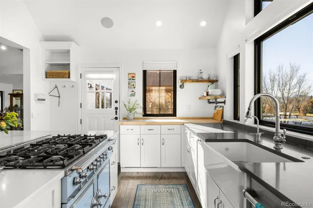 a kitchen with granite countertop a stove and a sink