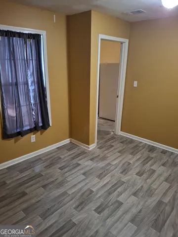 a view of a room with wooden floor and a cabinet