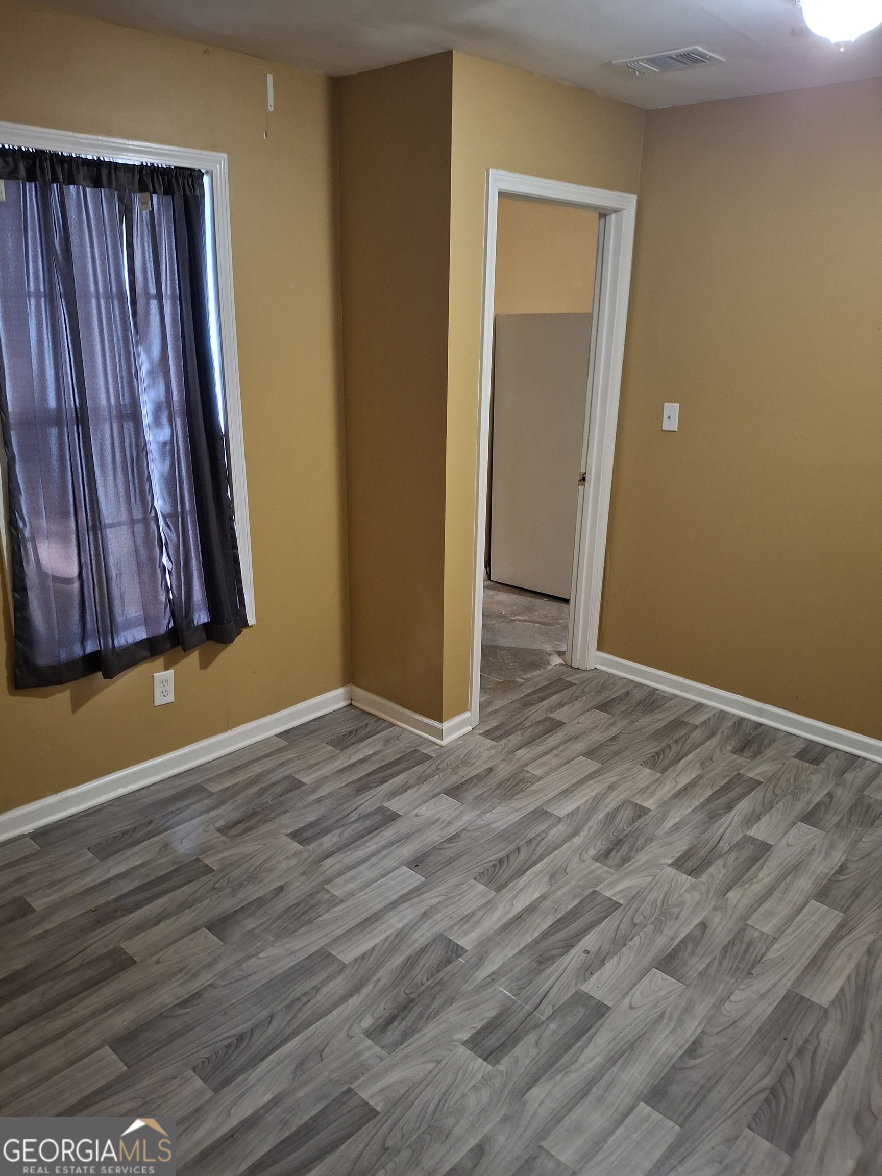 3284 Clubside View Court Southwest Snellville, GA 30039 - Photo 3 of 10 a view of a room with wooden floor and a cabinet