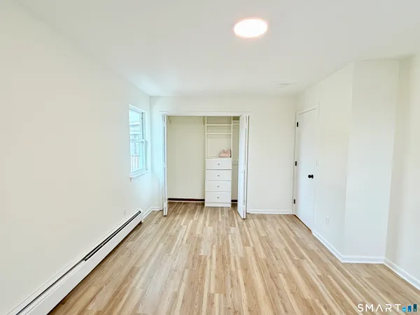 a view of a room with wooden floor