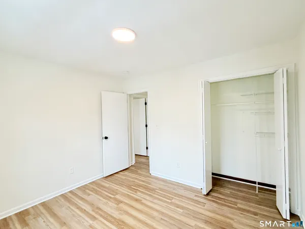 a view of a room with wooden floor