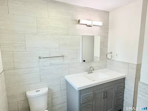 a bathroom with a sink toilet and vanity
