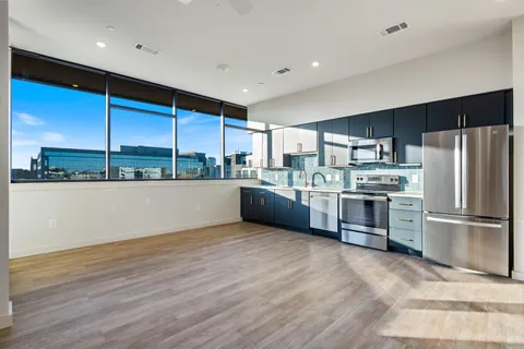 a kitchen with stainless steel appliances a sink and a refrigerator