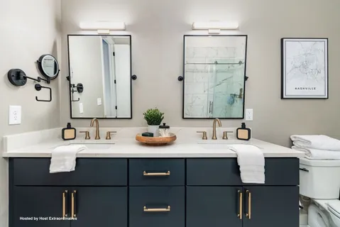 a bathroom with a granite countertop sink and a mirror