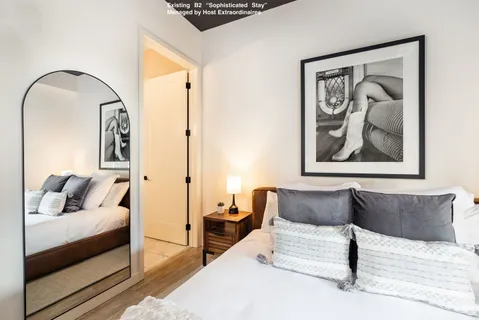 a bedroom with furniture and a painting on the wall