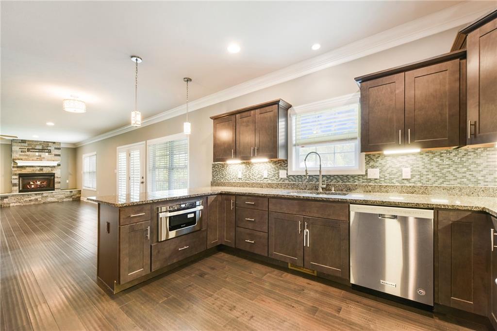 103 Timothy Trail Beaver, PA 15009 - Photo 5 of 25 a kitchen with stainless steel appliances granite countertop wooden cabinets a sink dishwasher a stove and a refrigerator with wooden floor