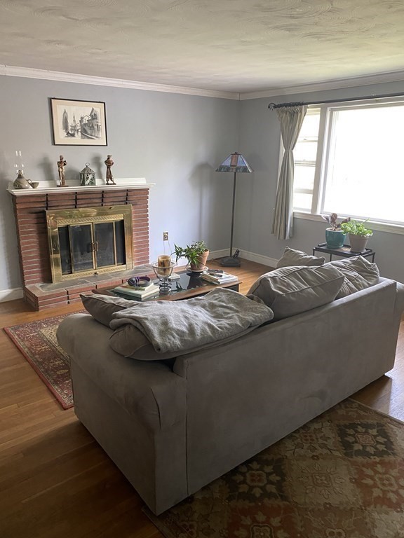68 Thayer Circle Randolph, MA 02368 - Photo 5 of 25 a living room with fireplace furniture and a flat screen tv