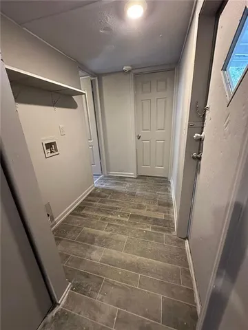 an empty room with wooden floor and window