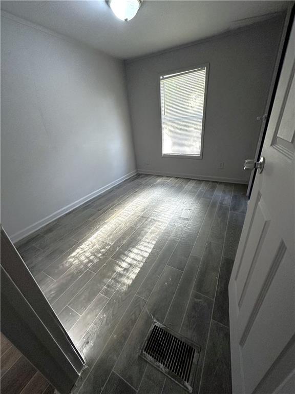 114 Skyland Drive East Locust Grove, GA 30248 - Photo 10 of 10 wooden floor in an empty room with a window