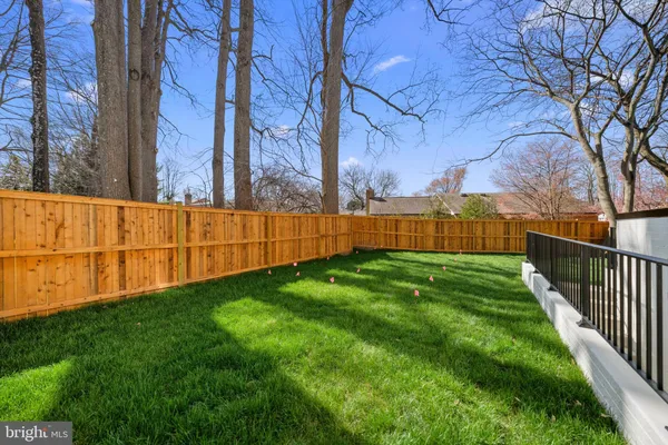 a view of yard with wooden fence