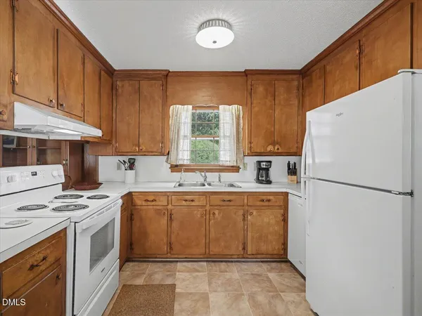 a view of a dining room with furniture and a window