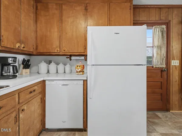 a kitchen with a stove a refrigerator and a sink
