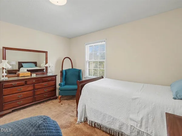 a view of a hallway with wooden floor and a bathroom