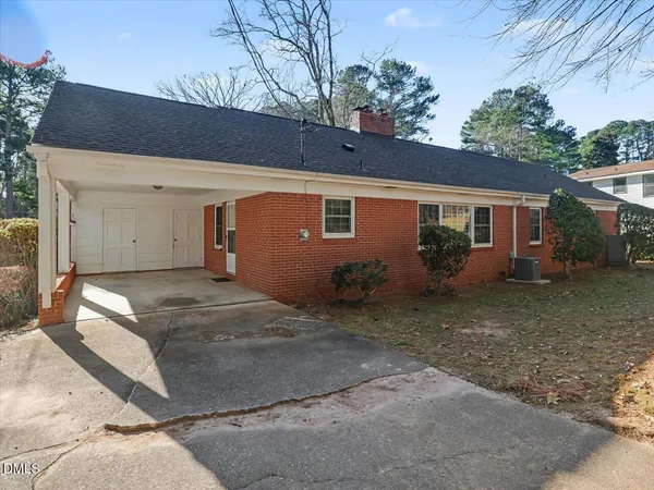 a view of a house with a backyard and garage