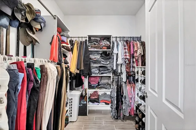a bathroom with a granite countertop sink a toilet a mirror and shower