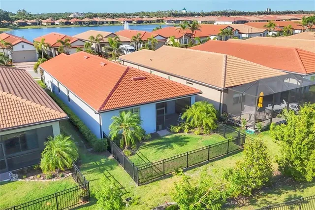 a living room with furniture large window and chandelier
