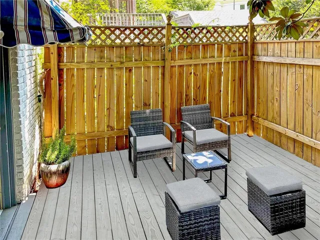 a view of a balcony with chairs and wooden floor