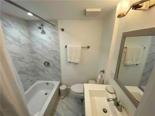 a bathroom with a sink a toilet and a bathtub