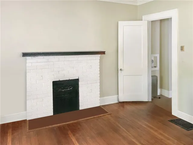 a view of an empty room and wooden floor