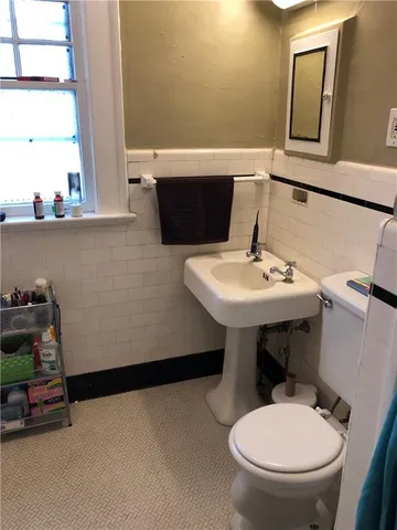 a bathroom with a sink toilet and mirror